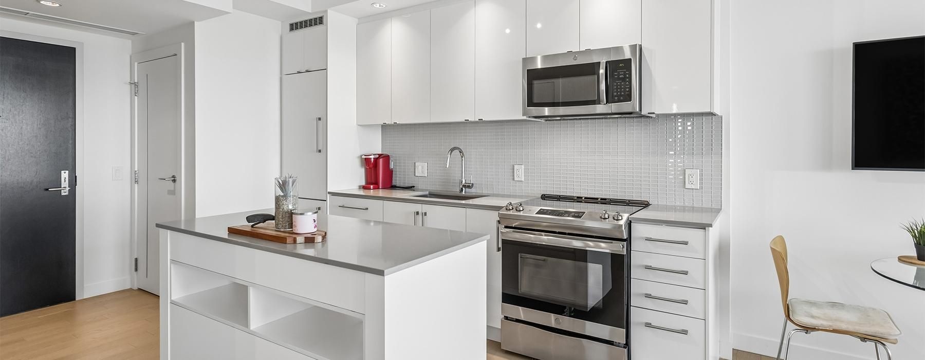 a kitchen with white cabinets