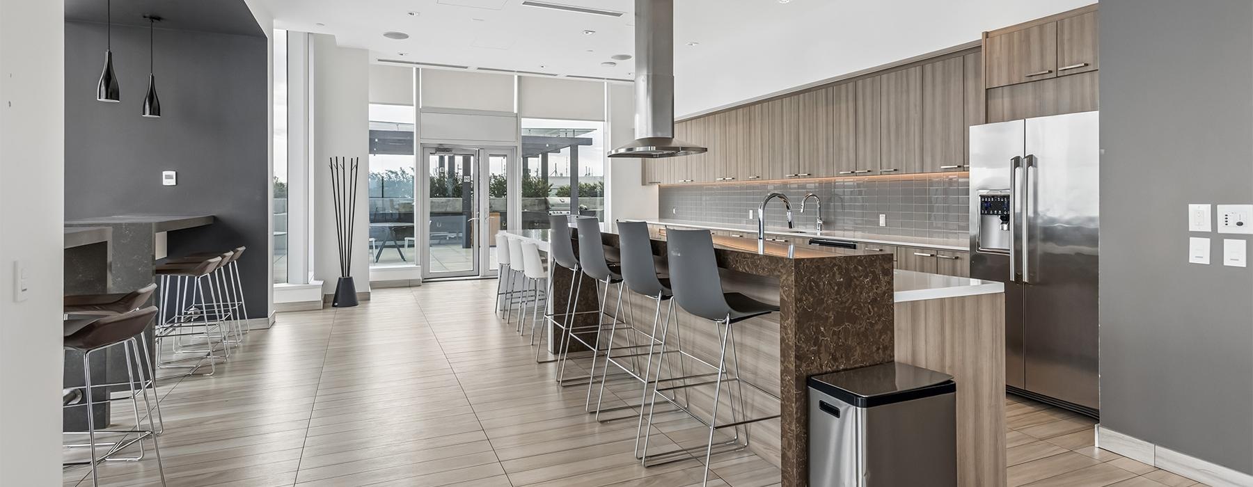 a kitchen with a bar and chairs
