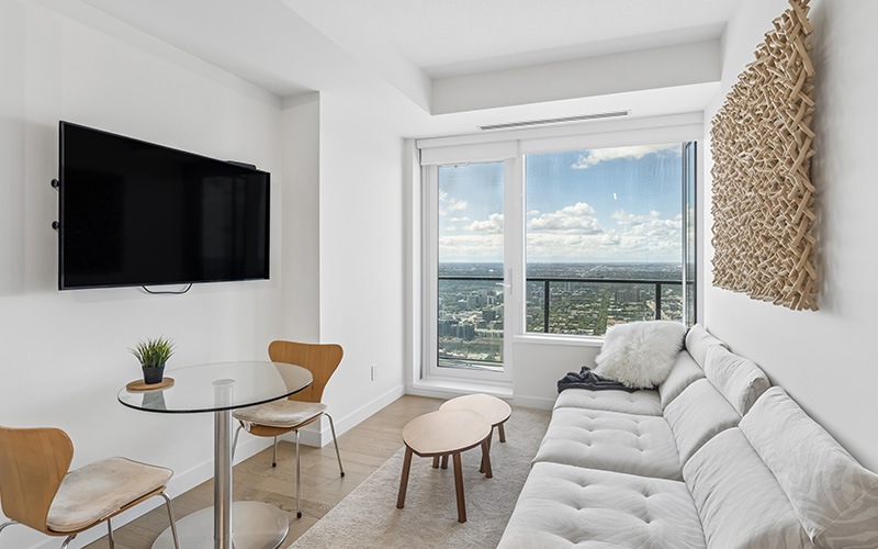 living room with a couch windows and view of a kitchen