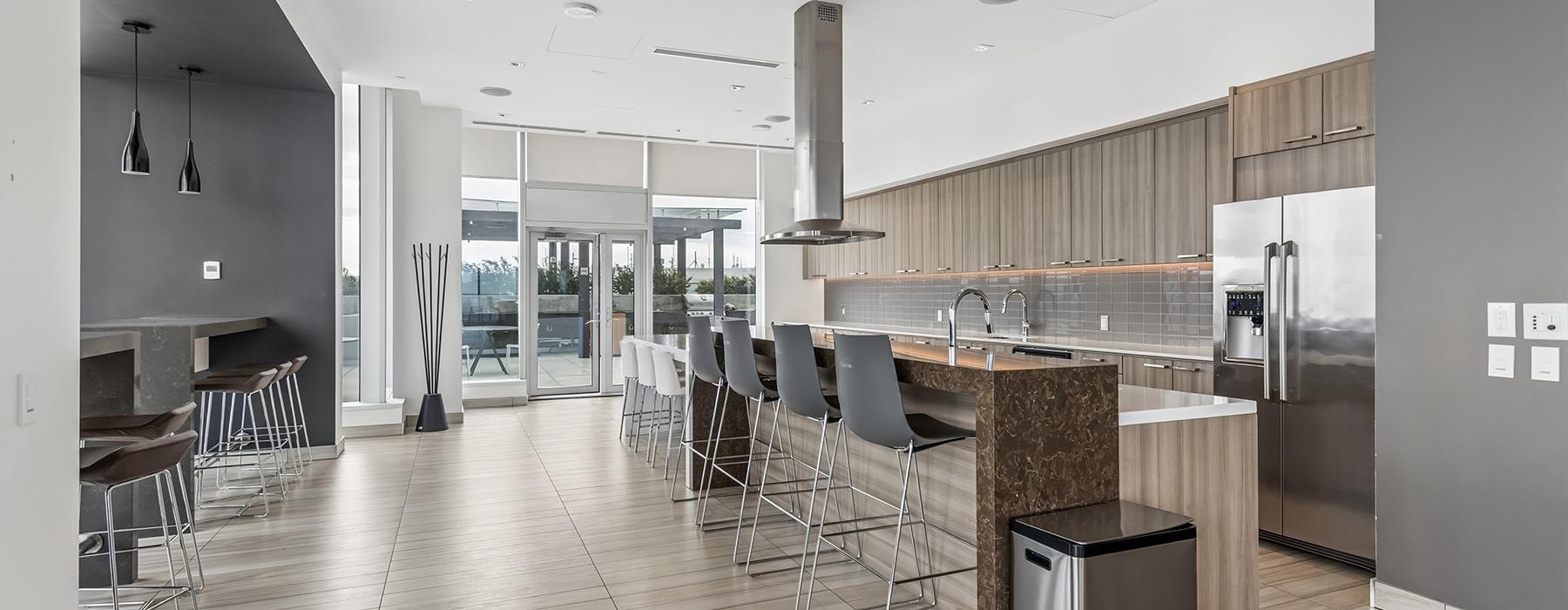a kitchen with a bar and chairs