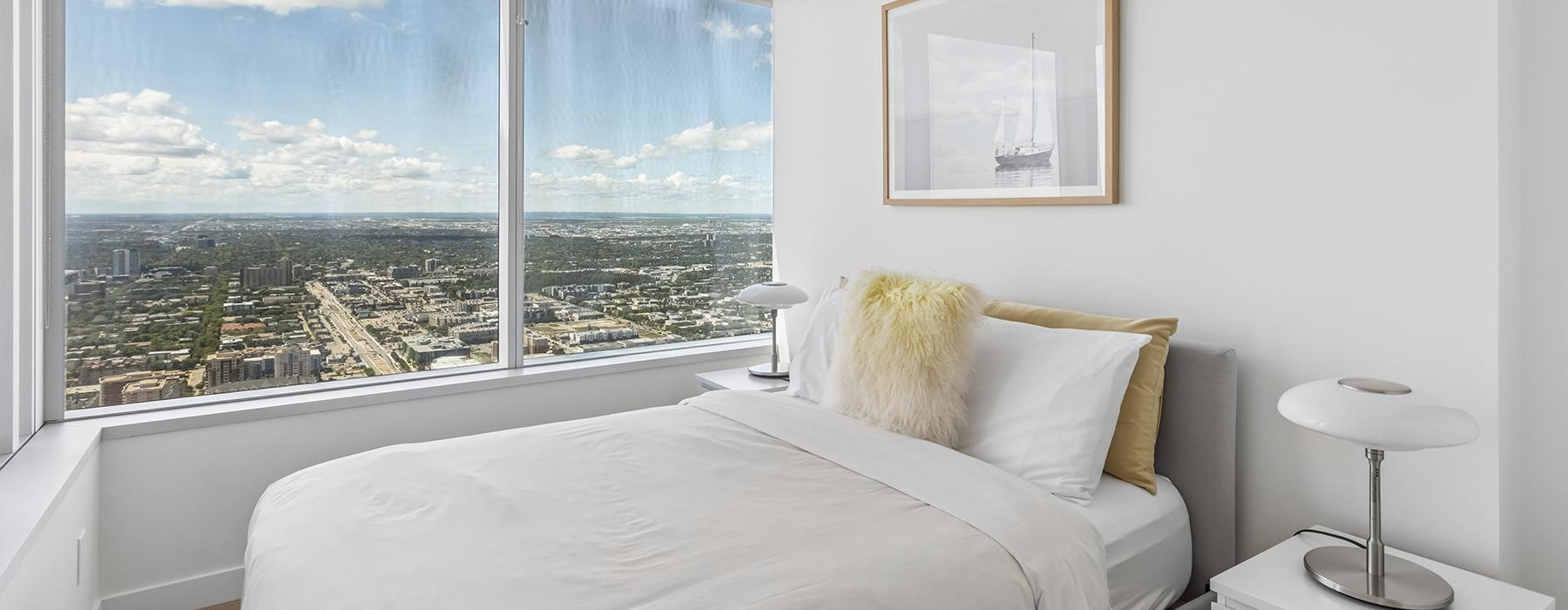 a bedroom with a large window